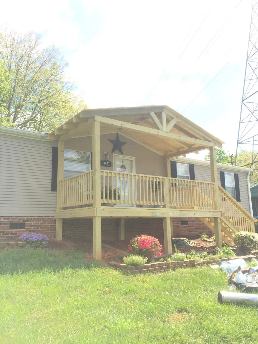 New gabled porch roof and deck railing added to a ranch home in Quincy